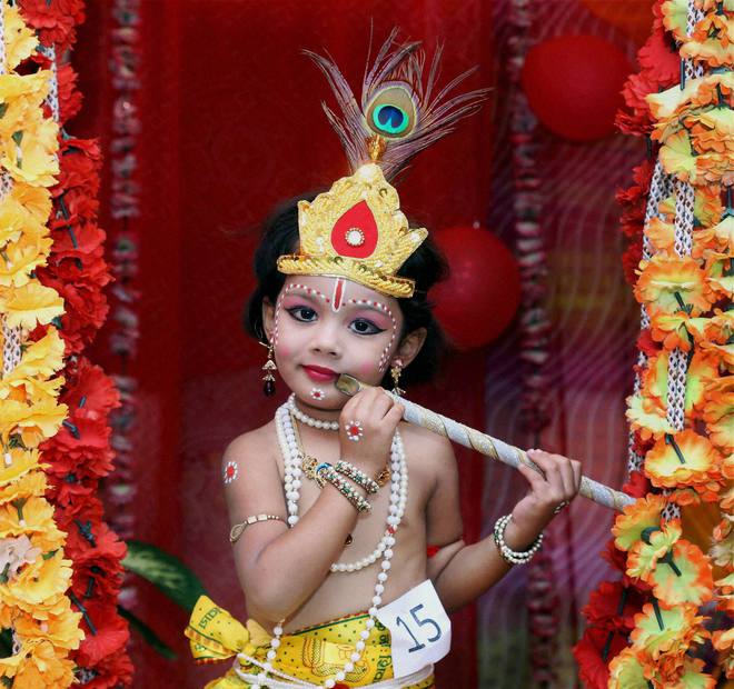 A child dressed as Lord Krishna for a school function ahead of Janmashtami festival at Beawar, Rajasthan.