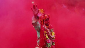 A devotee takes part in rituals on Laddu Holi at Radha Rani temple in Barsana, Uttar Pradesh
