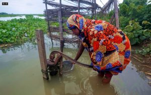 A flood affected woman collects water from a hand pump at Sildubi village in Assam’s Morigaon district on July 5, 2021