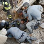 A man is rescued alive from the ruins following an earthquake in Amatrice, central Italy, on August 24, 2016. Central Italy was struck by a powerful 6.2-magnitude earthquake in the early hours