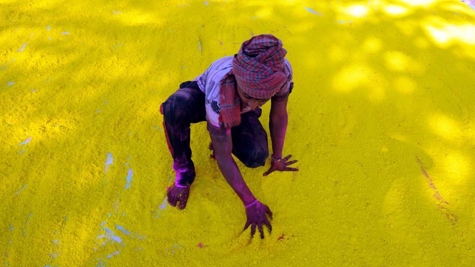 A man makes Gulal powder for use in the coming festival of Holi