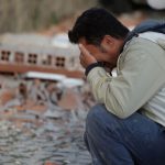 A man reacts after a strong earthquake hit Amatrice, central Italy, on August 24, 2016.