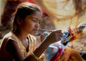 A young artist gives finishing touches to an idol of Lord Krishna ahead of Janmashtami in Bikaner, Rajasthan.