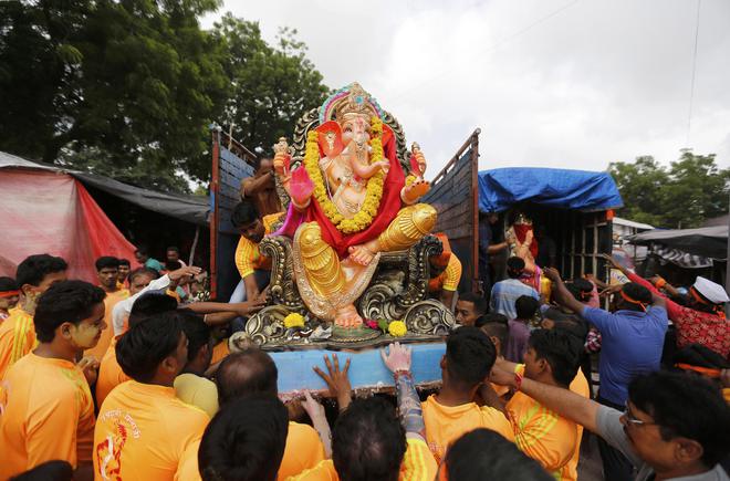An idol of the Hindu god Ganesh, the deity of prosperity, is loaded unto a supply truck on the first day of the Ganesh Chaturthi festival in Ahmedabad on September 5, 2016.