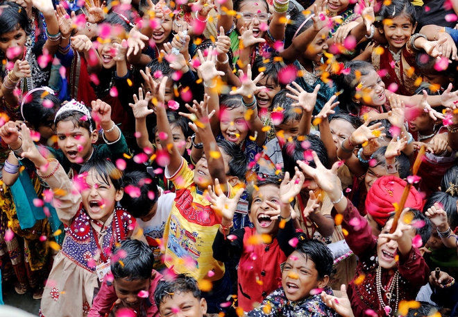 Children cheer as they celebrate Janmashtami festival in Ahmedabad.