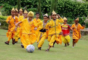 Children dressed as Lord Krishna participate in a football match during the Janmashtami celebration at a school in Patiala.