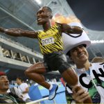 Fans hold a figure of Usain Bolt of Jamaica in the stands after Bolt won the gold medal in the men's 100m final.