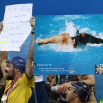 Fans hold placards in support of USA’s Michael Phelps in the Men’s 4 x 100-meter medley relay final during the swimming competitions at the 2016 Summer Olympics, August 14, 2016, in Rio de Janeiro, Brazil.