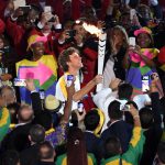 Former Brazilian tennis player Gustavo Kuerten carries the Olympic torch during the opening ceremony of the Rio 2016 Olympic Games at Maracana Stadium in Rio de Janeiro on August 5, 2016.