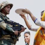 Girls tie Rakhi on the wrists of BSF jawans, near International Border RS Pura, in Jammu
