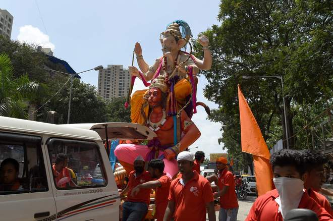 Indian Hindu devotees transport an idol of the elephant-headed Hindu god, Lord Ganesha for Ganesh Chaturthi in Mumbai on September 5, 2016.