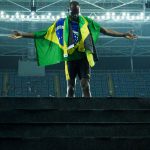 Jamaica’s Usain Bolt poses with the Jamaican flag after Team Jamaica won the men’s 4x100m Relay Final during the athletics event at the Rio 2016 Olympic Games at the Olympic Stadium in Rio de Janeiro on August 19, 2016