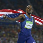Jeff Henderson of United States celebrates by running with a flag after his gold medal win in Men’s long jump at the Olympic Stadium in Rio de Janeiro, Brazil, on August 13, 2016.