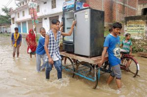 People move to safer places in flood-affected Vindhyachal Dham in Mirzapur, Uttar Pradesh, on August 22, 2016