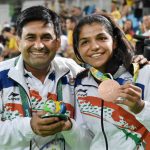 Sakshi Malik and her coach Kuldeep Singh celebrate after winning bronze against Kyrgyzstan's Aisuluu Tynybekova in the women's wrestling freestyle 58kg competition