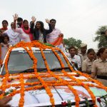 Sakshi Malik waves to a cheering crowd in Rohtak after arriving from Rio