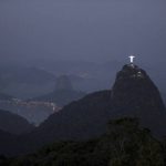 The Christ the Redeemer statue and Sugar Loaf mountain stand at dusk before the opening ceremony at the 2016 Summer Olympics in Rio de Janeiro, Brazil on August 5, 2016.