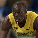 Usain Bolt of Jamaica gets into the starting blocks.