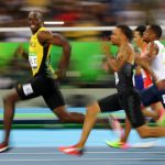 Usain Bolt of Jamaica looks at Andre De Grasse of Canada as they compete in the semifinal of the Men’s 100m.