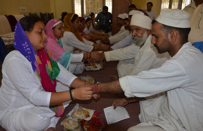 Women tie rakhi on wrist of Jail Inmates on occasion of Raksha Bandhan at Ambhalla jail in Jammu