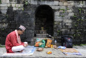 A Nepalese Hindu Brahmin priest waits for devotees during the Rishi Panchami festival in Kathmandu on September 6.