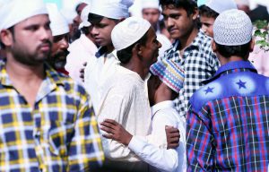 A boy hugs his relative each other after attending Eid al-Adha prayers at a mosque in Karnal