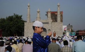 A boy offers Eid al-Adha prayers at the prayer ground in Jammu
