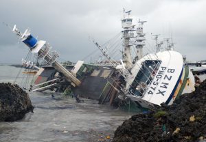 A general view shows an overturned fishing boat in the aftermath of super typhoon Meranti, at Sizihwan in Kaohsiung on September 15, 2016.