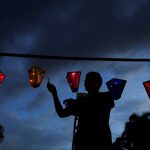A man lights up candles during the Lantern Festival celebrating the eve of the nativity of the Virgin Mary in Ahuchapan, El Salvador, on September 7, 2016.