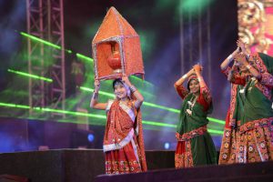 Chinese folk dancer Kan Li Na, 11, (L) from Beijing performs with Indian folk dancers during the full dress rehearsal on the eve of Vibrant Navratri Mahotsav at the GMDC ground, late September 30, 2016. Folk dancers from across India are participating in the Vibrant Navratri Mahotsav as the Hindu Navratri — the Dance Festival of Nine Nights — begins on October 1, 2016.
