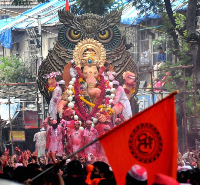 Devotees carry the Lalbaugcha Raja idol to Girgaon Chawpatty for immersion on the last day of Ganesh festival, in Mumbai.