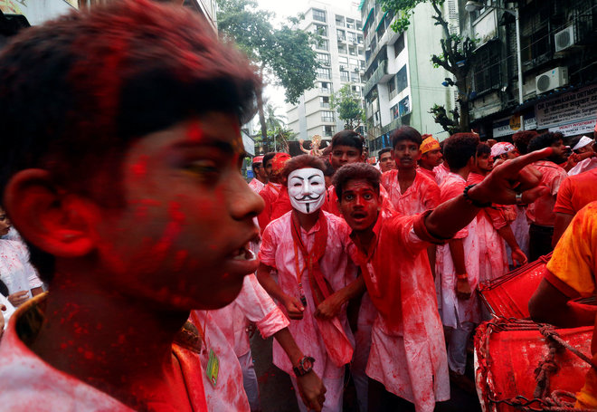 Devotees dance on a street as they celebrate the last day of the Ganesh Chaturthi festival in Mumbai.