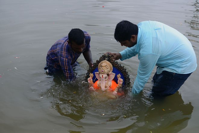 Devotees immerse an idol of the Hindu god Ganesh in the Hussain Sagar Lake during the Ganesh Chaturthi festival in Hyderabad.