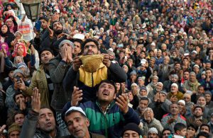 Devotees pray as a cleric displays a relic believed to be a hair from the beard of Prophet Mohammad during Eid-e-Milad, the birth anniversary of the Prophet, at the Hazratbal Shrine in Srinagar on December 12, 2016.