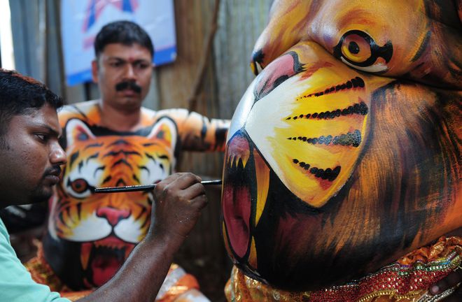 Indian artists prepare to take part in Tiger Dance in Thrissur