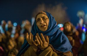 Kashmiri Muslim women react as a priest (not pictured) displays a relic believed to be a hair from the beard of Prophet Mohammad during Eid-e-Milad, the birth anniversary of the Prophet, at the Hazratbal Shrine in Srinagar on December 12, 2016.