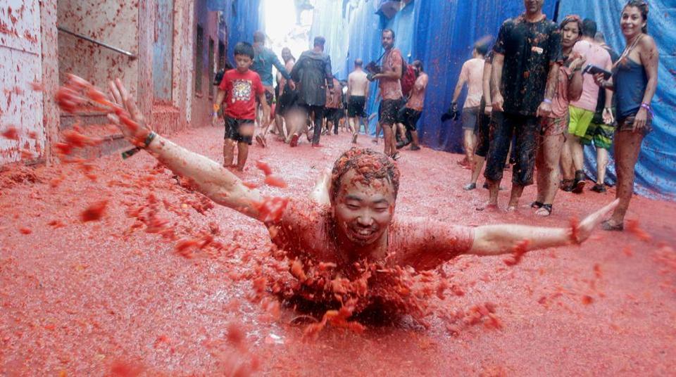La Tomatina, is a Spanish festival held in the Valencian town of Buñol, in the East of Spain. In this particular festival participants come from all over the world to get involved in harmless fight where more than one hundred metric tons of over ripe tomatoes are thrown in the street.