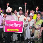 Members of the Aam Aadmi Party hold a candlelight march on Shaheed Bhagat Singh's birth anniversary in Bathinda