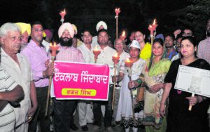 Members of the Aam Aadmi Party hold a candlelight march on Shaheed Bhagat Singh's birth anniversary in Bathinda