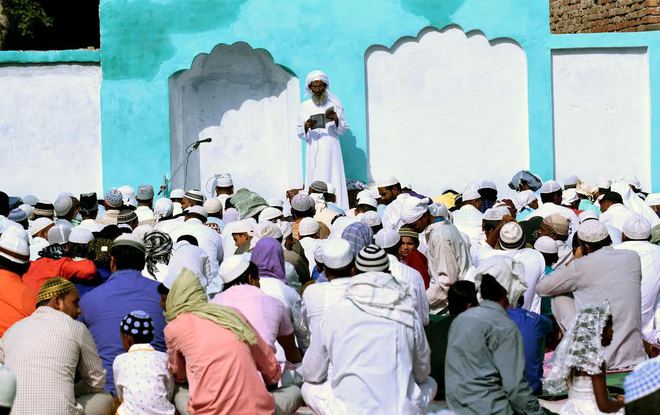 Men attend Eid al-Adha prayers in Karnal