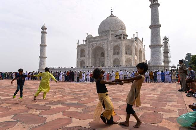 Muslim children play in the courtyard during the Eid al-Adha festival at the mosque inside the Taj Mahal in Agra