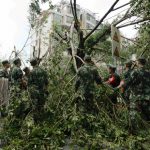 Paramilitary policemen remove toppled trees after Typhoon Meranti swept through Xiamen, Fujian province, China, on September 15, 2016.