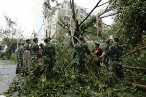 Paramilitary policemen remove toppled trees after Typhoon Meranti swept through Xiamen, Fujian province, China, on September 15, 2016.