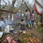 People cook their meal next to fallen trees after Hurricane Matthew passes Jeremie, Haiti, on October 5, 2016.