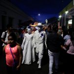 Performers walk along the street during the Lantern Festival celebrating the eve of the nativity of the Virgin Mary in Ahuchapan, El Salvador, on September 7, 2016.