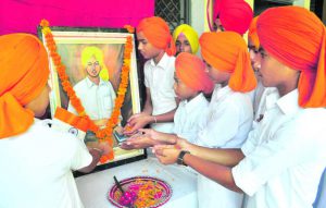 Students pay floral tributes to Shaheed Bhagat Singh on his birth anniversary at Lucky Modern High School in Patiala