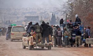 Syrian rebel fighters and civilians who were evacuated from rebel-held neighbourhoods in the embattled city of Aleppo arrive in the opposition-controlled Khan al-Aassal region, west of the embattled city, on December 16, 2016.