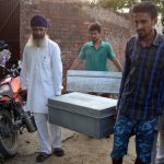 Villagers from the India-Pakistan border area carry luggage as they leave their border village near Mahawa, about 40 kms from Amritsar on September 29.