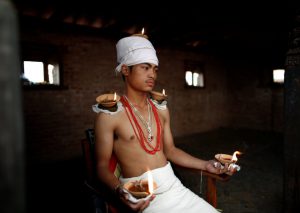 A devotee offers oil lamps on top of his body while offering prayers during ‘Dashain’, a Hindu religious festival in Bhaktapur, Nepal, on October 11, 2016.