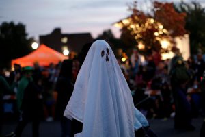 A man in a ghost costume marches in the annual Nyack Halloween Parade in the Village of Nyack, New York, on US, October 29, 2016.